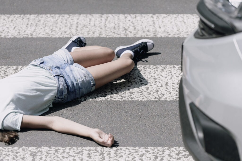 Teenager school girl with backpack and bike walk in pedestrian crossing in front of a car