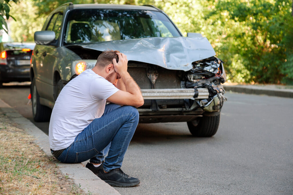 Man holding his head after car accident